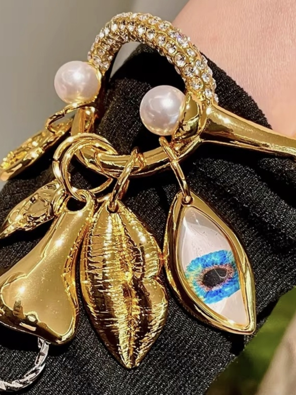 Schiaparelli Inspired Gold Charm Bracelet with Pearl Accents and Blue Eye Charm